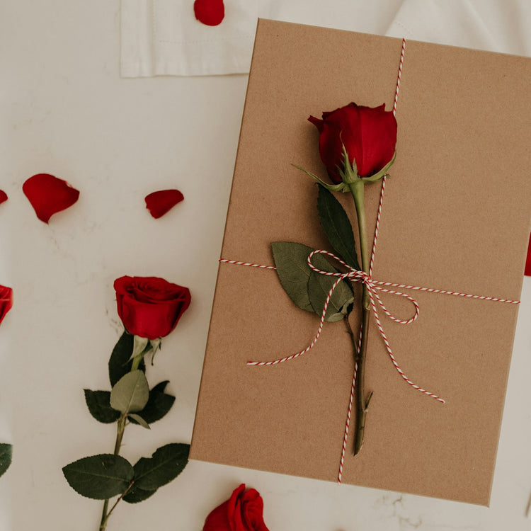 Red rose on a brown envelope