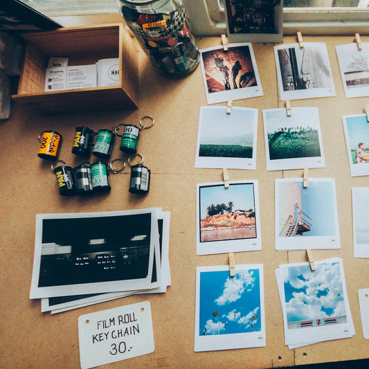 Printed photos spread on a wooden table