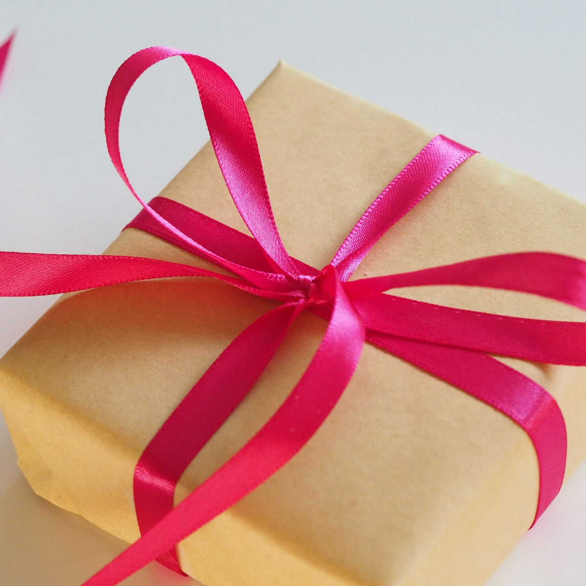 Gift box tied with a pink ribbon